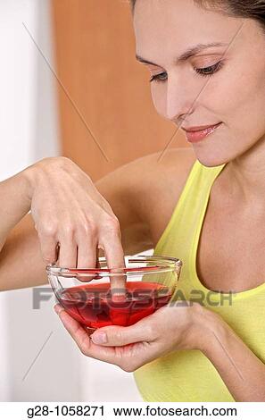 Woman desinfecting her finger View Large Photo Image Stock Image - Woman desinfecting her finger. Fotosearch