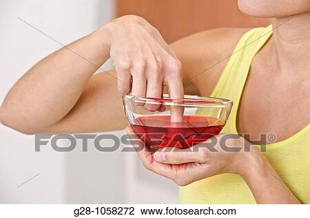 Woman desinfecting her finger View Large Photo Image Stock Image - Woman desinfecting her finger. Fotosearch