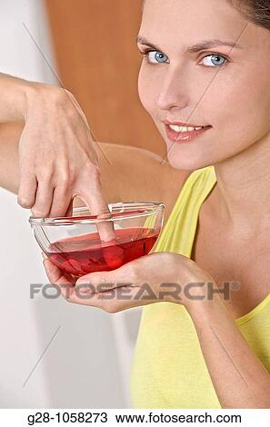 Stock Image - Woman desinfecting her finger. Fotosearch