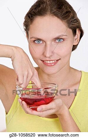 Stock Image - Woman desinfecting her finger. Fotosearch