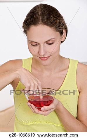 Woman desinfecting her finger View Large Photo Image Stock Photo - Woman desinfecting her finger. Fotosearch