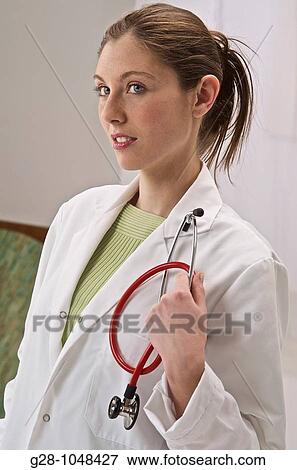 woman doctor in white gown with red stethodcope View Large Photo Image Stock Photo - woman doctor in white gown with red stethodcope. Fotosearch