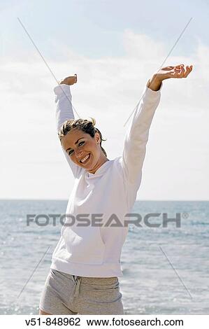 Woman doing exercise by the sea View Large Photo Image Stock Image - Woman doing exercise by the sea. Fotosearch
