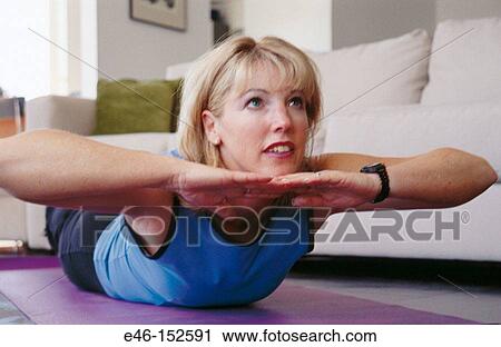 Woman doing exercises at home View Large Photo Image Stock Image - Woman doing exercises at home. Fotosearch