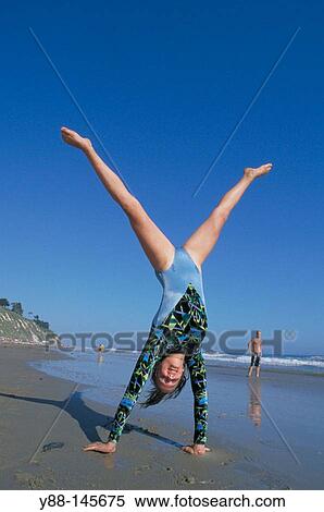 Woman doing handstand on the beach View Large Photo Image Stock Photography - Woman doing handstand on the beach. Fotosearch