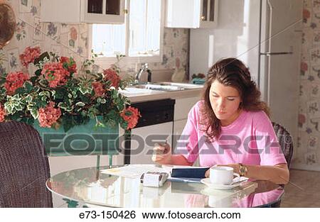 Stock Photograph - Woman doing home finances. Fotosearch