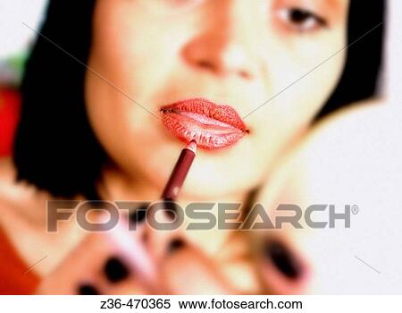 Woman doing makeup, lipstick View Large Photo Image Stock Photography - Woman doing makeup, lipstick. Fotosearch