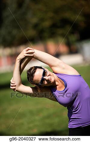 Woman doing workout outdoors. View Large Photo Image Stock Photo - Woman doing workout outdoors.. Fotosearch