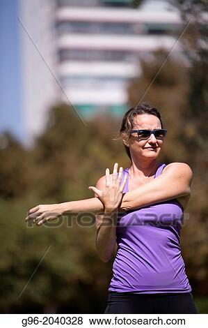 Stock Photo - Woman doing workout outdoors.. Fotosearch