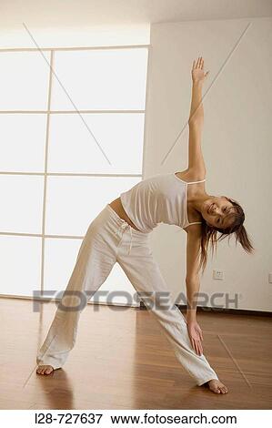 Woman doing yoga at Home View Large Photo Image Stock Photo - Woman doing yoga at Home. Fotosearch