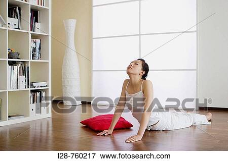 Stock Photo - Woman Doing Yoga At Home. Fotosearch