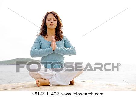 Woman doing yoga in a dock by the sea View Large Photo Image Stock Image - Woman doing yoga in a dock by the sea. Fotosearch
