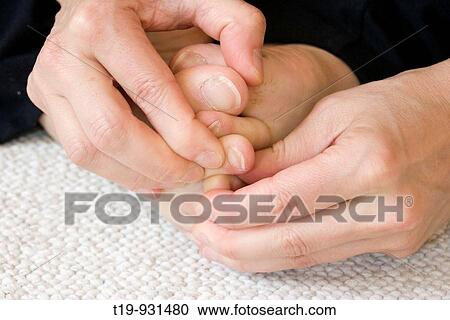 Stock Image - Woman doing yoga in a studio Pose: on the way to? Pada pada mudra? MR. Fotosearch