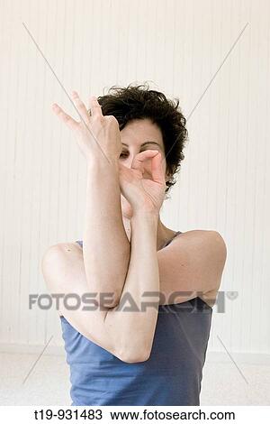 Stock Image - Woman doing yoga in a studio Pose:? mudra? MR. Fotosearch