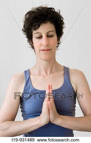 Woman doing yoga in a studio Pose:? Anjali mudra? a k a? Namaste? MR View Large Photo Image Stock Photo - Woman doing yoga in a studio Pose:? Anjali mudra? a k a? Namaste? MR. Fotosearch