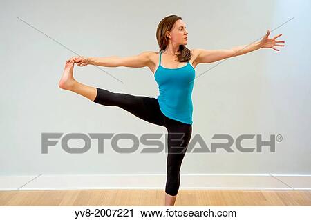 Woman doing yoga in extended hand-to-big toe pose. View Large Photo Image Stock Image - Woman doing yoga in extended hand-to-big toe pose.. Fotosearch