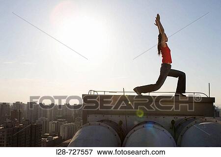 Woman doing yoga on roof View Large Photo Image Stock Photo - Woman doing yoga on roof. Fotosearch