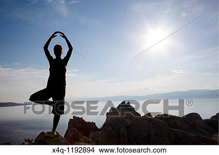 Picture - woman doing yoga. Fotosearch