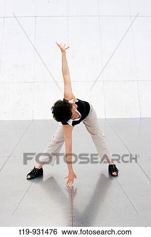 Woman doing yoga pose: Pyramid Twist on metal panels MR View Large Photo Image Stock Photograph - Woman doing yoga pose: Pyramid Twist on metal panels MR. Fotosearch