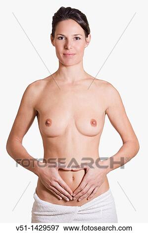 Stock Photo - Woman drawing a heart in her belly at studio. Fotosearch