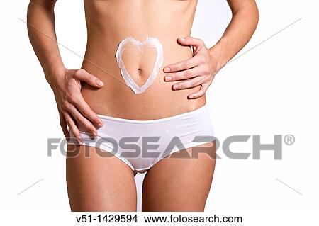 Woman drawing a heart in her belly with cream View Large Photo Image Picture - Woman drawing a heart in her belly with cream. Fotosearch