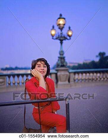 Woman dressed with a red jump suit on Alexandre III bridge at twilight, Paris, France View Large Photo Image Picture - Woman dressed with a red jump suit on Alexandre III bridge at twilight, Paris, France. Fotosearch