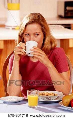 Stock Photo - woman drinking a cup of coffee. Fotosearch