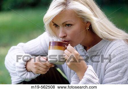 woman drinking coffee/tea outdoors View Large Photo Image Stock Photo - woman drinking coffee/tea outdoors. Fotosearch
