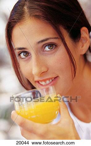 Woman drinking orange juice View Large Photo Image Picture - Woman drinking orange juice. Fotosearch