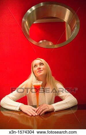 Woman drinking red cocktail View Large Photo Image Picture - Woman drinking red cocktail. Fotosearch
