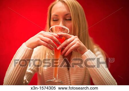 Woman drinking red cocktail View Large Photo Image Stock Photography - Woman drinking red cocktail. Fotosearch