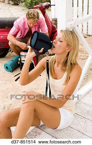 Picture - Woman drinking water from a water bottle. Fotosearch