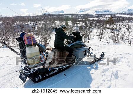 Woman driving snowmobile in winter landscape in mountain area in swedish lapland View Large Photo Image Stock Photography - Woman driving snowmobile in winter landscape in mountain area in swedish lapland. Fotosearch