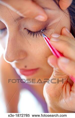 Stock Photography - Woman during eye lashes extensions. Fotosearch