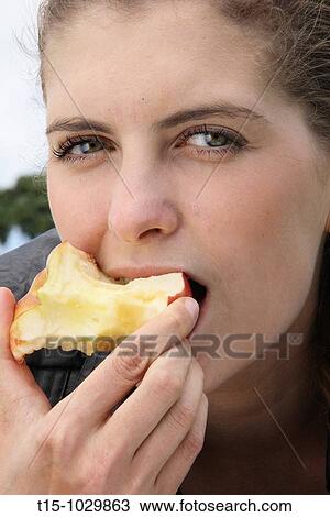 woman eating an apple View Large Photo Image Stock Image - woman eating an apple. Fotosearch