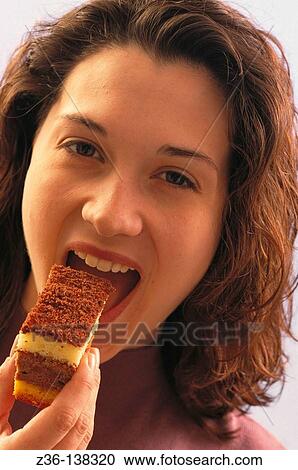 Woman eating cake View Large Photo Image Stock Image - Woman eating cake. Fotosearch