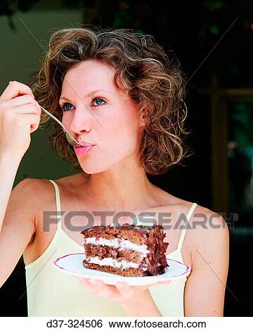 Woman eating cake View Large Photo Image Stock Photograph - Woman eating cake. Fotosearch
