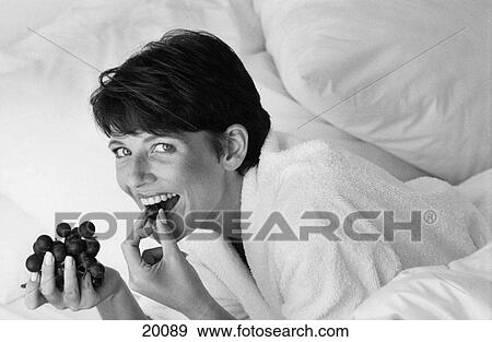 Woman eating grapes View Large Photo Image Stock Photo - Woman eating grapes. Fotosearch