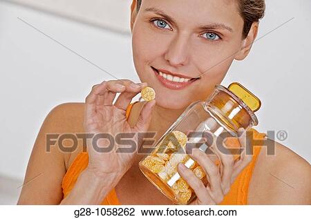 Woman eating honey sweets for sore throat View Large Photo Image Stock Image - Woman eating honey sweets for sore throat. Fotosearch