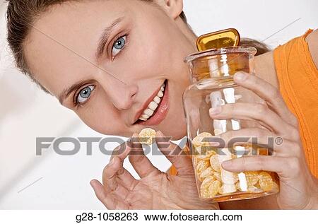 Woman eating honey sweets for sore throat View Large Photo Image Stock Image - Woman eating honey sweets for sore throat. Fotosearch