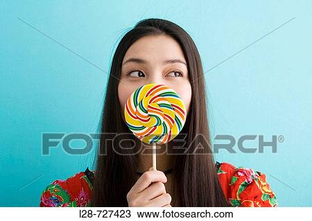 Woman eating lollipop View Large Photo Image Stock Image - Woman eating lollipop. Fotosearch