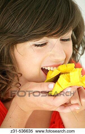 Woman eating mango View Large Photo Image Stock Photography - Woman eating mango. Fotosearch