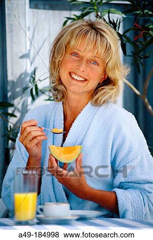 Woman eating melon View Large Photo Image Stock Photo - Woman eating melon. Fotosearch