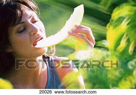 Woman eating melon View Large Photo Image Stock Photograph - Woman eating melon. Fotosearch