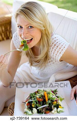 Woman eating salad View Large Photo Image Picture - Woman eating salad. Fotosearch