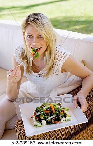 Stock Image - Woman eating salad. Fotosearch