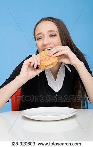 Stock Image - Woman Eating Sandwich. Fotosearch