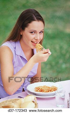 Woman eating spaghetti View Large Photo Image Stock Image - Woman eating spaghetti. Fotosearch