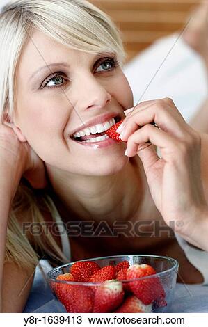 Stock Image - woman eating. Fotosearch