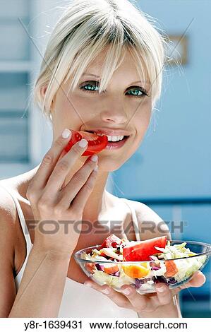 Stock Image - woman eating. Fotosearch